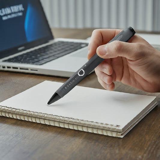 a hand holding a pen on a notebook