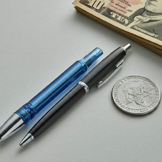 two pens with one coin on a surface