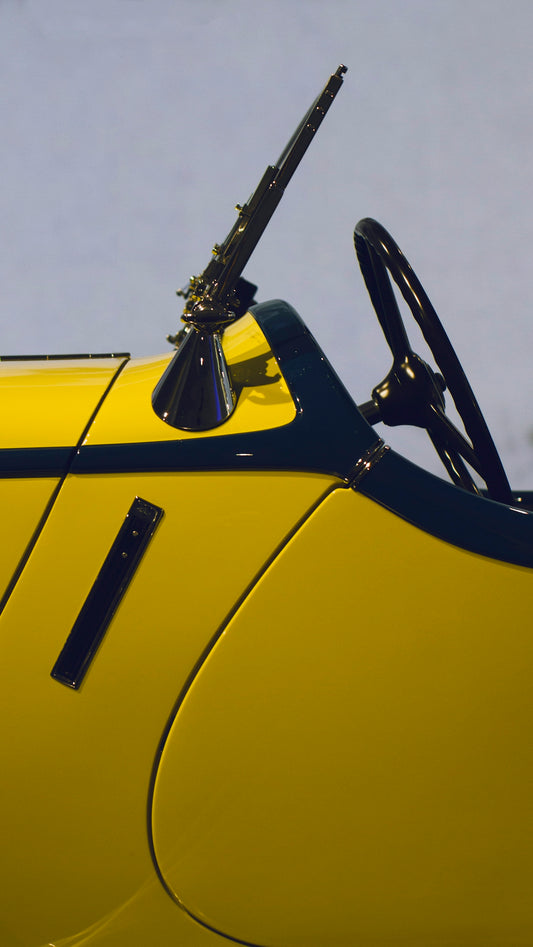 a yellow car with a black steering wheel