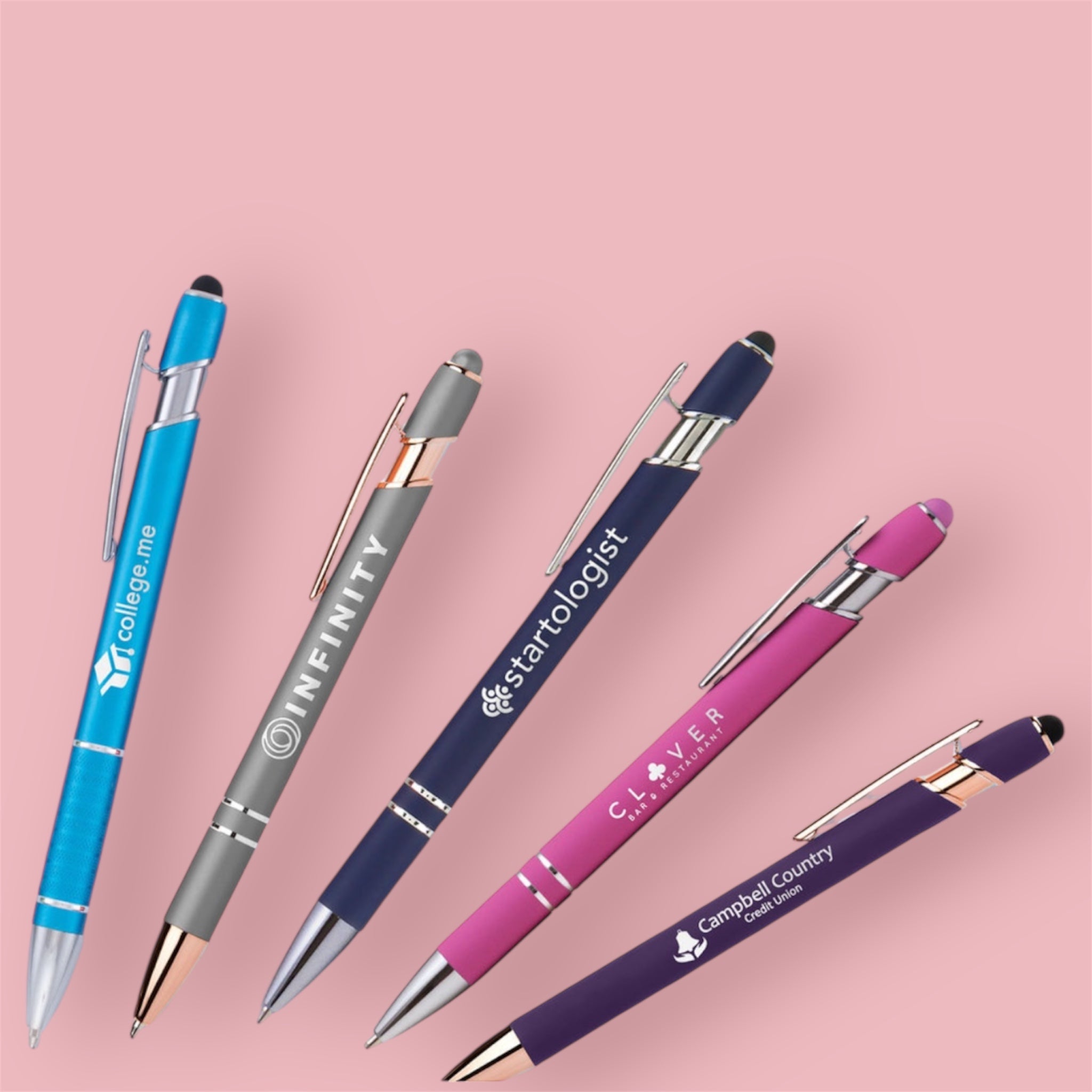 five coloured pens on pink surface