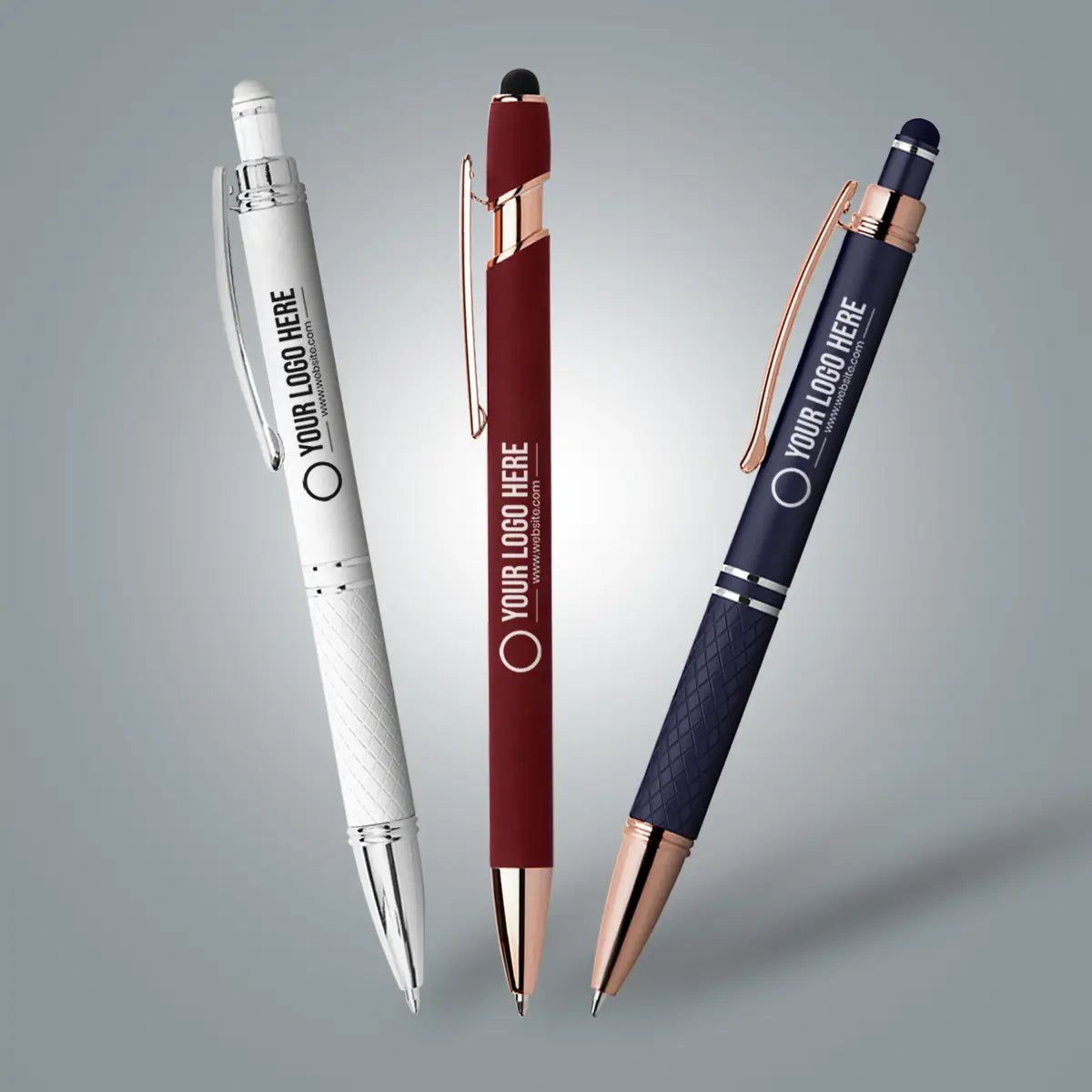 three colourful ballpoint ink pens with grey background