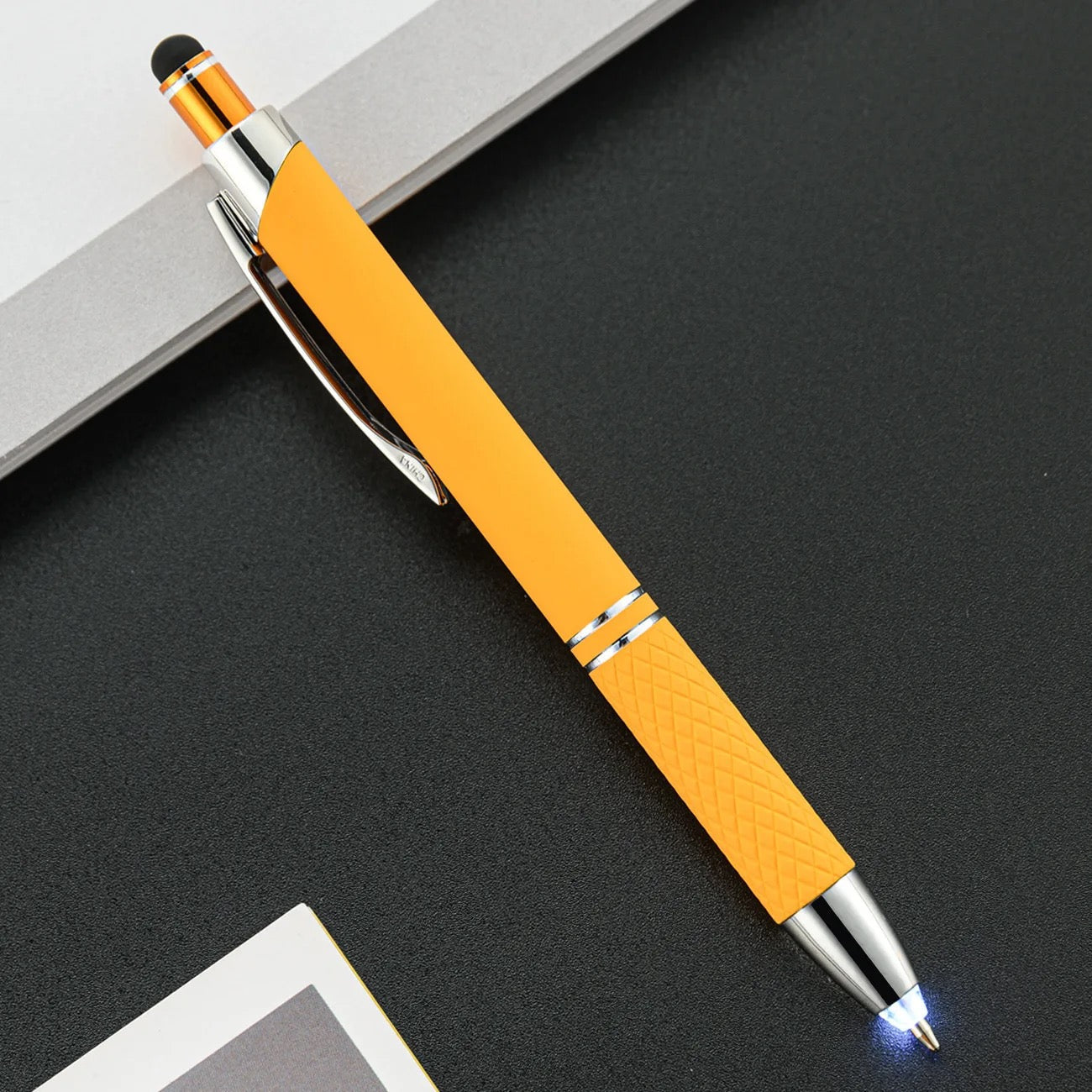 a yellow pen on a surface